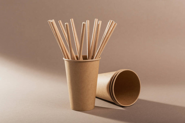 Catering and street fast food paper cups and straws. Accessories for eating and drinking outdoors. Ecology, recycling concept. - Фото, изображение