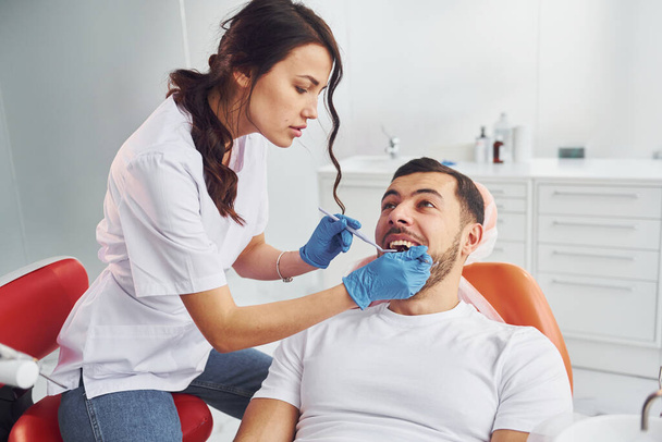 Man visiting dentist in clinic. Conception of stomatology. - Zdjęcie, obraz