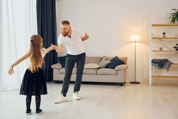 Learning to dance. Father with his little daughter is at home together. - Foto, Imagem
