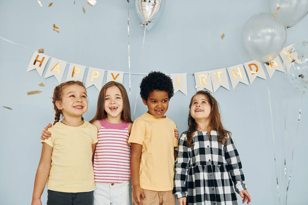 Posing for the camera. Children on celebrating birthday party indoors have fun together. - Foto, imagen