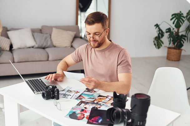 Photographer in casual clothes is working indoors at daytime. - Fotoğraf, Görsel