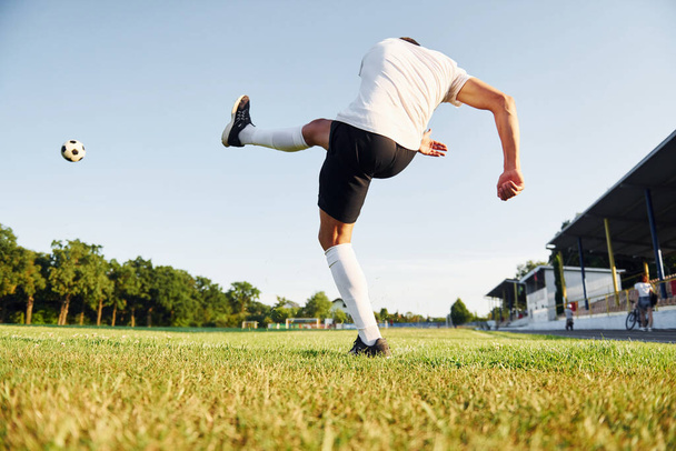 Kicks the ball. Young soccer player have training on the sportive field. - Zdjęcie, obraz