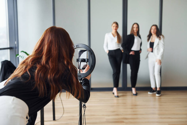 Backstage of photoshoot. Group of adult women that in formal clothes is indoors in the office together. - Φωτογραφία, εικόνα