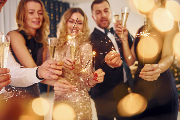 Celebration of new year. Group of people have a new year party indoors together. - Foto, Bild
