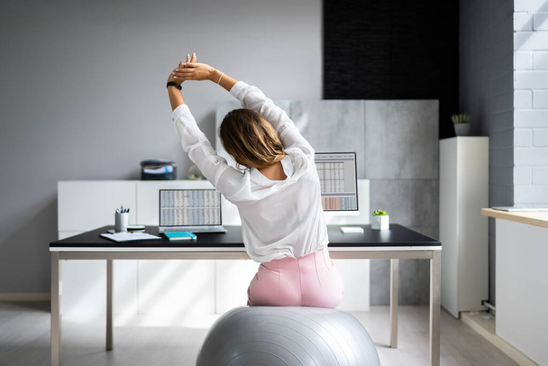 Employee Exercising On Ball In Office. Fitness And Health - Fotografie, Obrázek