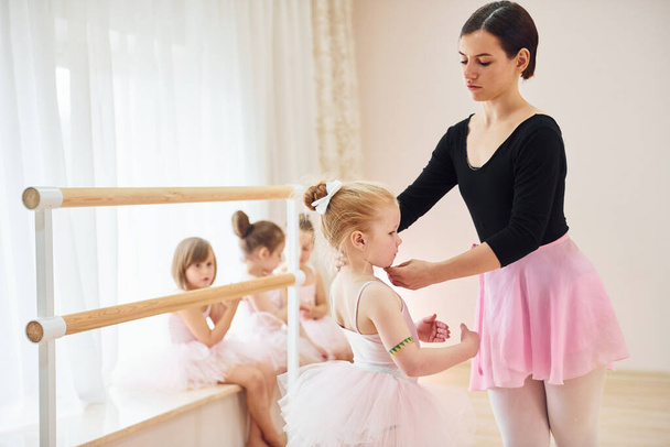 Fixing posture. Little ballerinas preparing for performance by practicing dance moves. - Zdjęcie, obraz