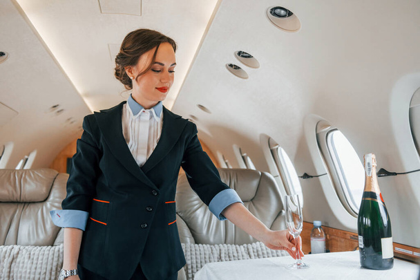 Young stewardess on the work in the passanger airplane. - Foto, Imagem