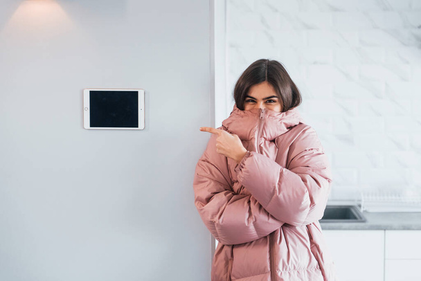 Climate control. Young woman is indoors in smart house room at daytime. - Photo, image