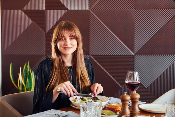 Woman have luxury dinner. Indoors of new modern luxury restaurant. - Foto, imagen