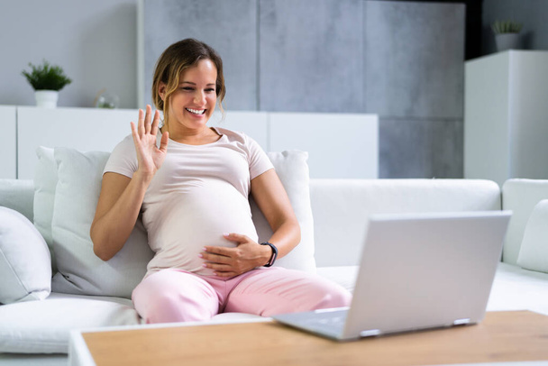 Pregnant Woman Using Online Video Call With Doctor On Laptop - Valokuva, kuva