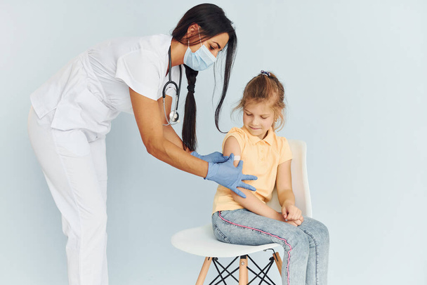 Doctor in uniform making vaccination to the little girl. - Foto, Imagem