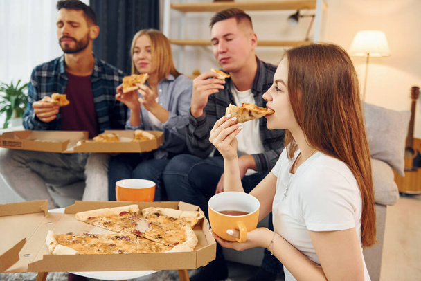 It's pizza time. Group of friends have party indoors together. - Fotoğraf, Görsel