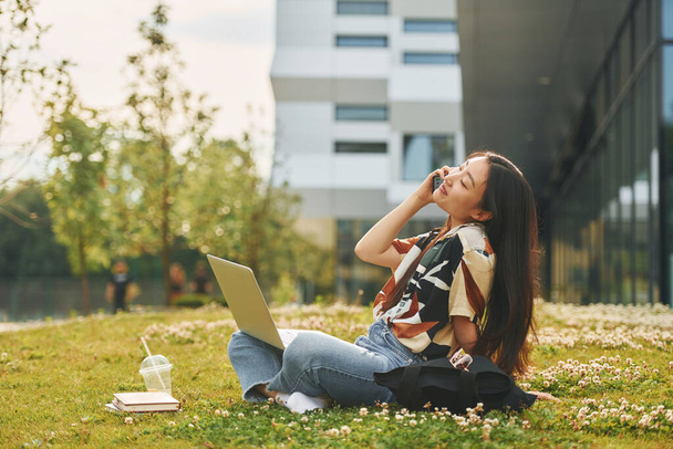 Conception of education. Young asian woman is outdoors at daytime. - Fotoğraf, Görsel