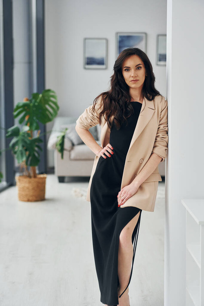European woman in fashionable stylish clothes is posing indoors. - Foto, Bild
