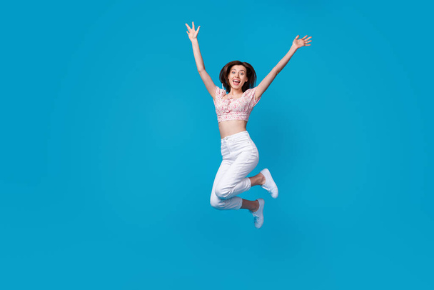 Photo of astonished lady dressed stylish clothes raise hand arm rejoice shopping discount empty space isolated on blue color background. - Foto, Bild
