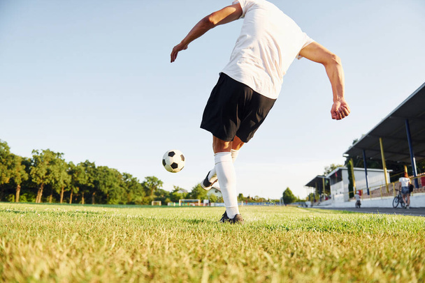 Kicks the ball. Young soccer player have training on the sportive field. - Photo, image