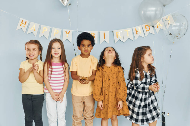 Children on celebrating birthday party indoors have fun together. - Valokuva, kuva