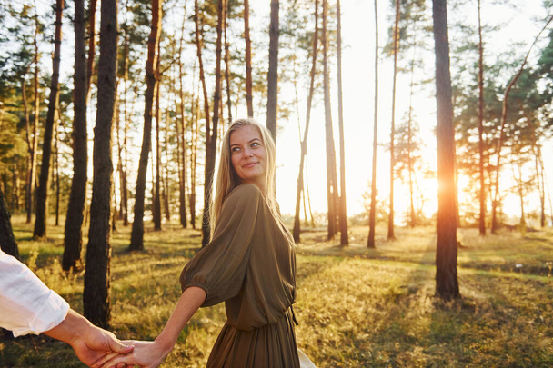 Follow me, concept. Happy couple is outdoors in the forest at daytime. - Valokuva, kuva