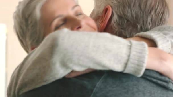 Love, home and couple hug together in romance, unity and partnership in a interior house or apartment. Senior marriage man and woman in a family home or support, trust and care for a romantic partner. - Filmati, video