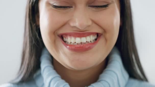Šťastný, úsměv se zuby a portrét ženy ve studiu s pozitivním a zdravým mentálním přístupem. Detailní záběr štěstí, mladý a tvář krásné dívky modelky stojící na bílém pozadí - Záběry, video