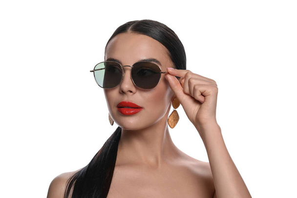 Attractive woman wearing fashionable sunglasses against white background - Fotó, kép