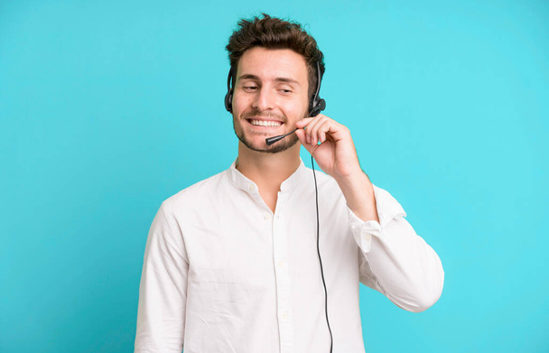 young handsome man isolated with operator headphones and micro. telemarketing concept - Foto, afbeelding