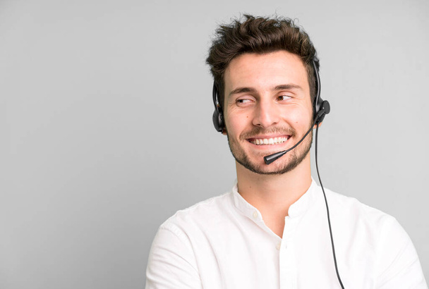 young handsome man isolated with operator headphones and micro. telemarketing concept - Fotó, kép