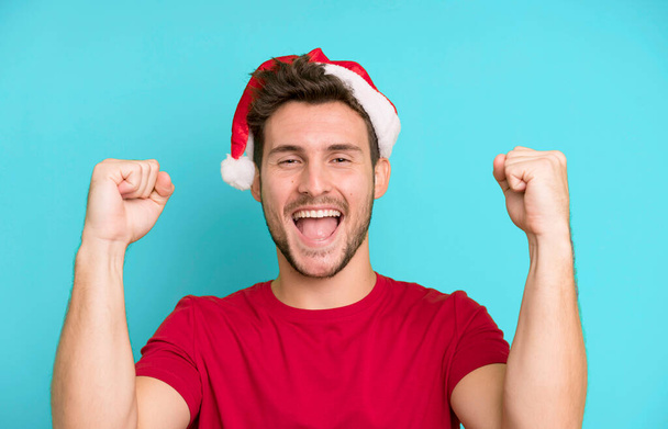 young handsome man with a santa hat. christmas concept - Foto, immagini