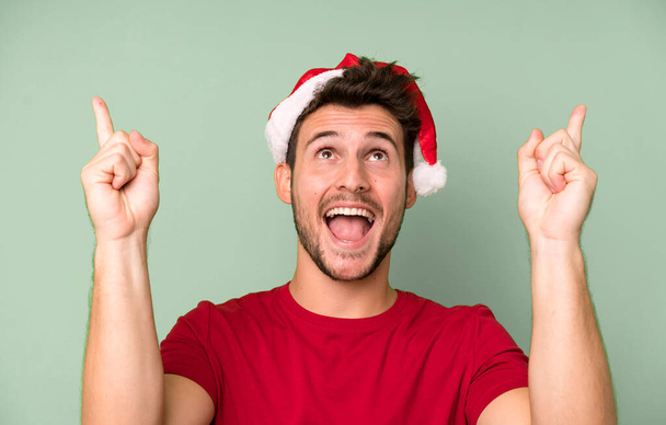 young handsome man with a santa hat. christmas concept - Foto, imagen