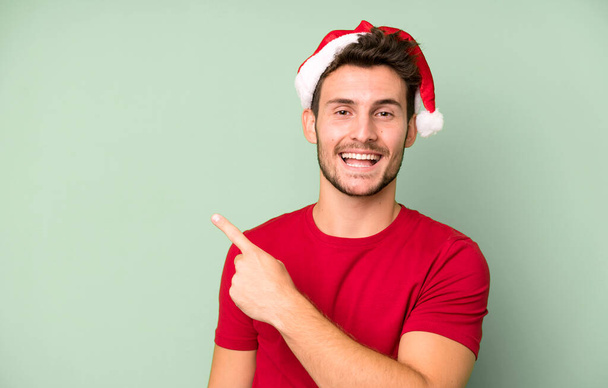young handsome man with a santa hat. christmas concept - Фото, зображення