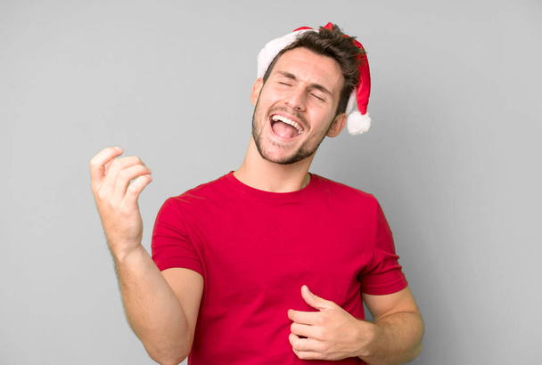 young handsome man with a santa hat. christmas concept - Фото, зображення