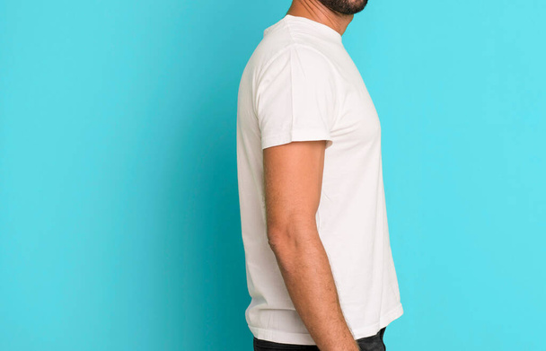 young crazy bearded and expressive man wearung an empty blank t shirt mock up - Fotó, kép