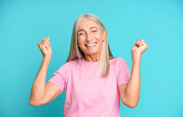 pretty gray hair senior woman looking extremely happy and surprised, celebrating success, shouting and jumping - Fotografie, Obrázek