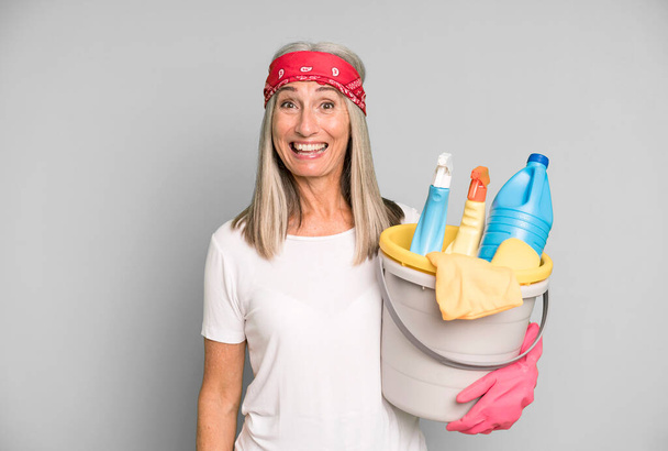 gray hair pretty woman looking happy and pleasantly surprised with clean products. housekeeper concept - Photo, image