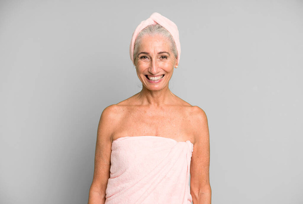 gray hair pretty woman looking happy and pleasantly surprised. wearing bathrobe and towel. beauty concept - Foto, Imagem
