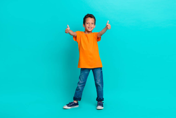 Photo of satisfied boy learner raise two arm show approval yes symbol enjoy nice lesson empty space isolated on cyan color background. - Foto, afbeelding
