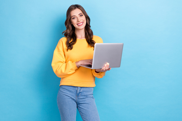 Photo of young positive pretty nice gorgeous girl businesswoman hold computer programmer toothy smile successful isolated on blue color background. - Φωτογραφία, εικόνα