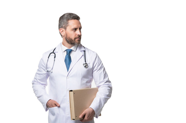 Doctor man holding folder. Doctor in white coat. Professional medical service. Doctor isolated on white, copy space. - Фото, зображення