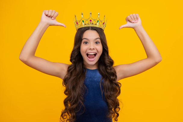 Teenager princess child celebrates success win and victory. Teen girl in queen crown. Excited face, cheerful emotions of teenager girl - 写真・画像