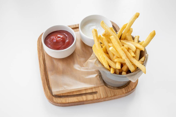 French Fries with tomato ketchup and mayo dip served in basket isolated on grey background top view - Fotoğraf, Görsel