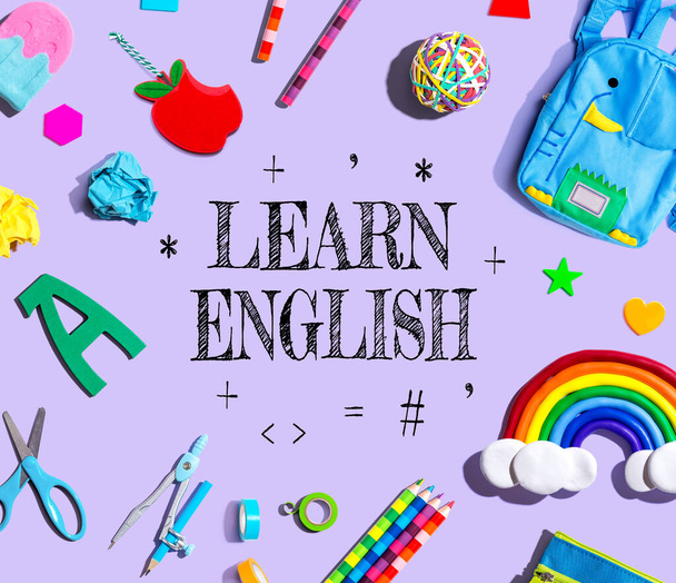Learn English theme with school supplies on a purple background - flat lay - 写真・画像