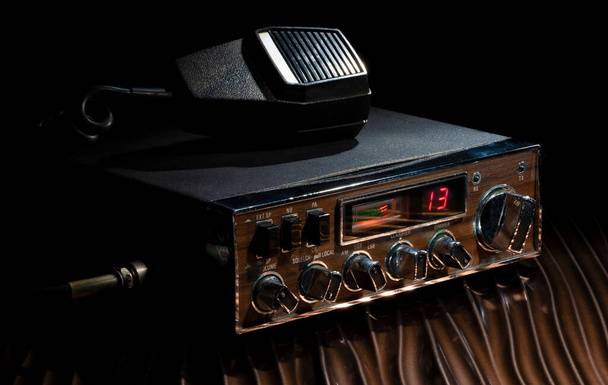 Two-way radio on a dark and wavy bronze colored surface - Foto, Imagem