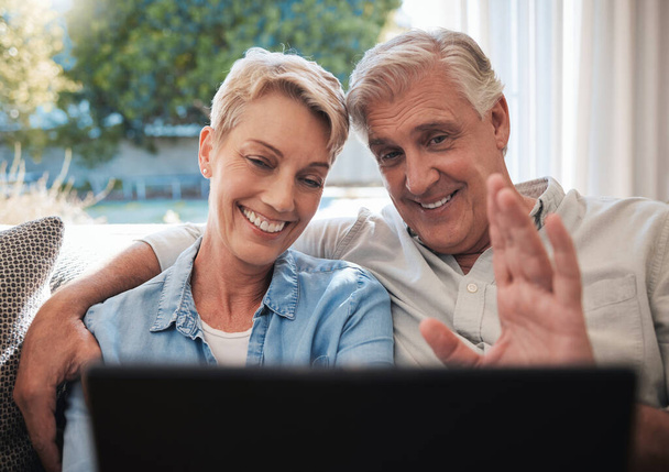Senior couple, laptop and video call greeting in living room talking, communication and speaking on sofa at house. Elderly, love and retirement man and woman on family home pc wifi video conference. - Photo, Image