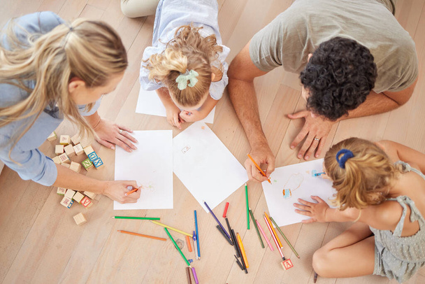 Family with creative children drawing on paper, home school and fun educational activity, learning and project. Above of parents, kids doodle, color and play for healthy growth, development and art. - Фото, зображення