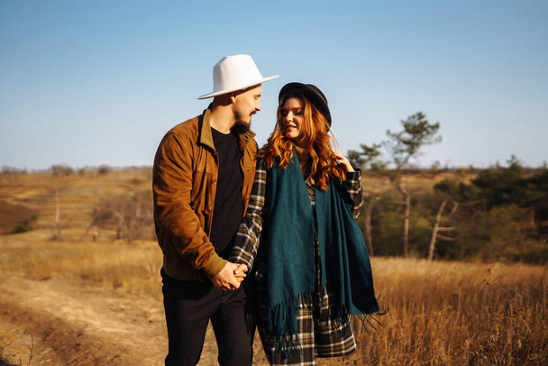 Lovely hipster couple resting in nature.  Autumn Fashion, style concept. - Foto, imagen