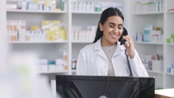 Φαρμακοποιός, Ινδή γυναίκα και τηλεφώνημα για ιατρική βοήθεια, ιατρική ασφάλιση και υποστήριξη χαπιών. Πορτρέτο του χαμόγελου, χαρούμενος ή εμπιστοσύνη φαρμακοποιός στο κατάστημα λιανικής πώλησης προϊόντων με τεχνολογία υπολογιστών. - Πλάνα, βίντεο