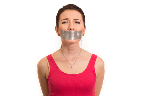 Woman in red with gaffer tape on her mouth experiencing emotional pain isolated - Photo, Image