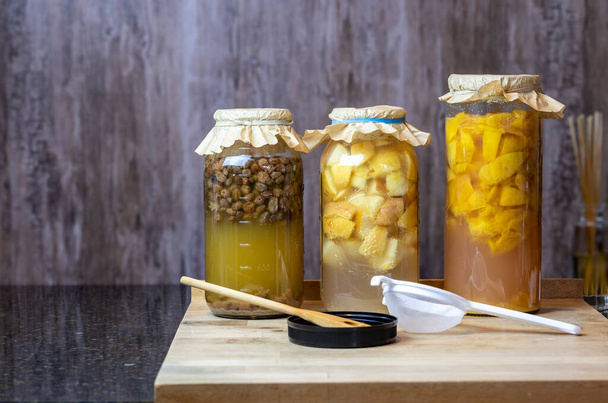 Raisin, apple and peach fermentation into homemade vinegars for food preservation and storage - Photo, Image
