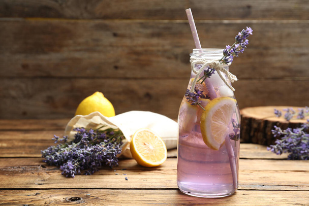 Fresh delicious lemonade with lavender on wooden table - Фото, изображение