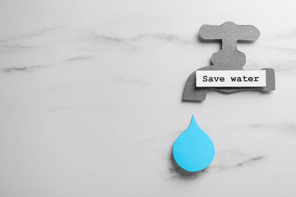 Paper tap with words Save Water and drop on white table, flat lay. Space for text - Photo, image